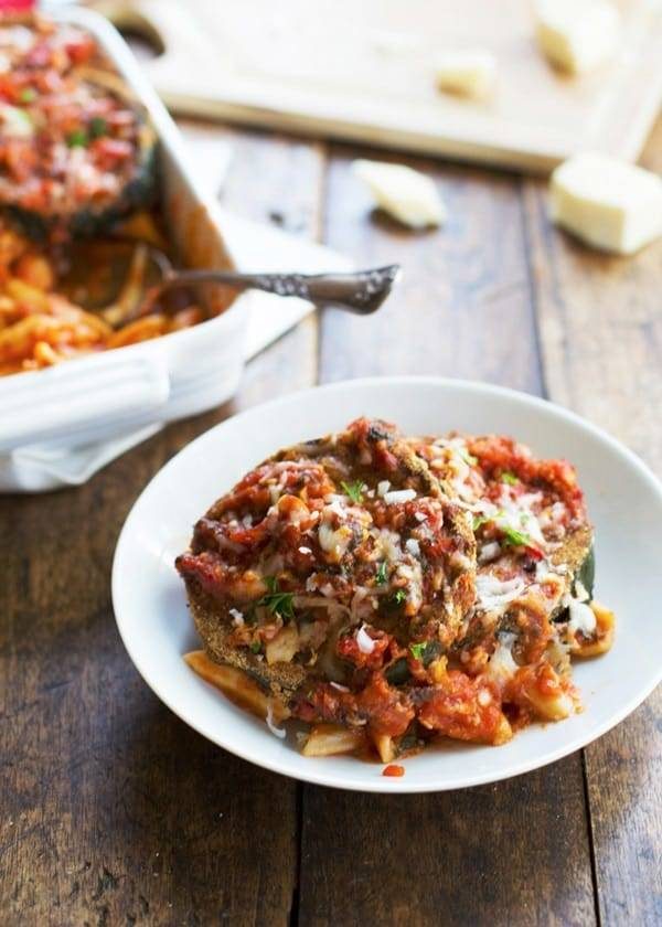 Baked Zucchini Parmesan on a plate and in a baking dish.