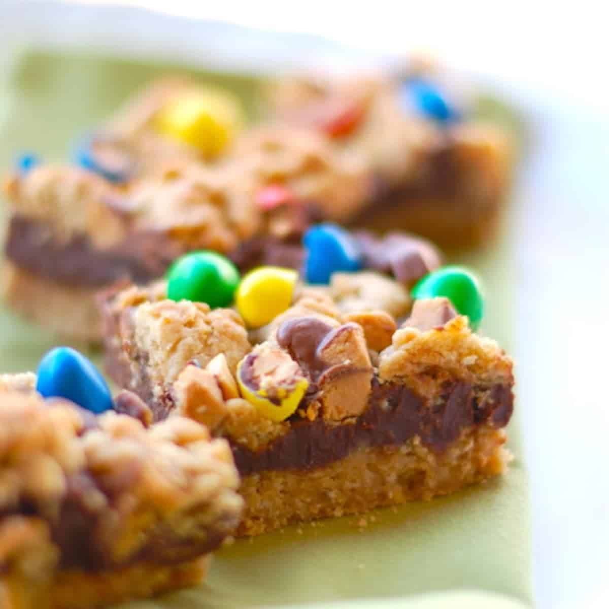 Candy fudge bars on a green napkin.