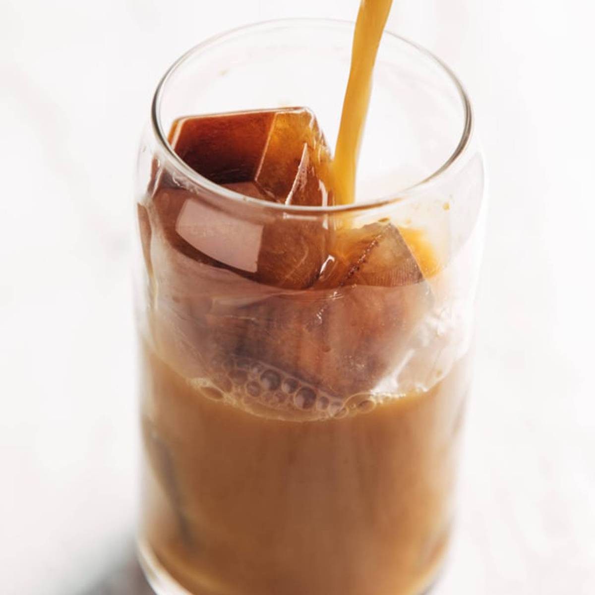 Pouring cold brew into a glass