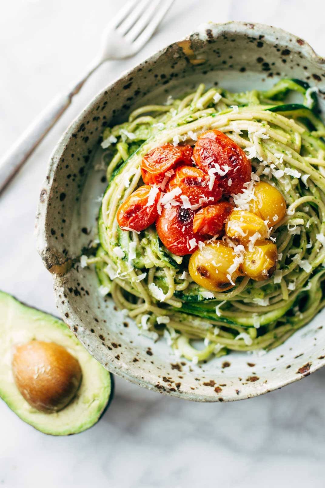 Zucchini spaghetti with tomato topping in a bowl.