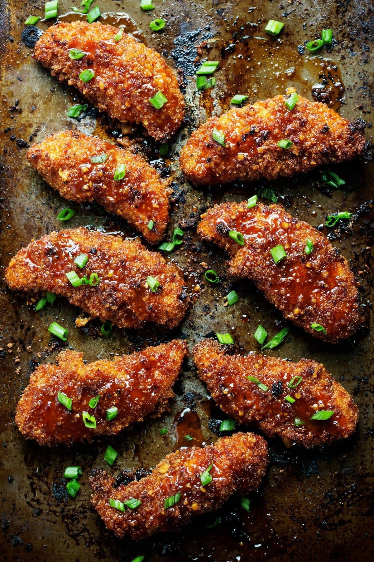 Sticky Garlic Chicken with green onions on a pan.