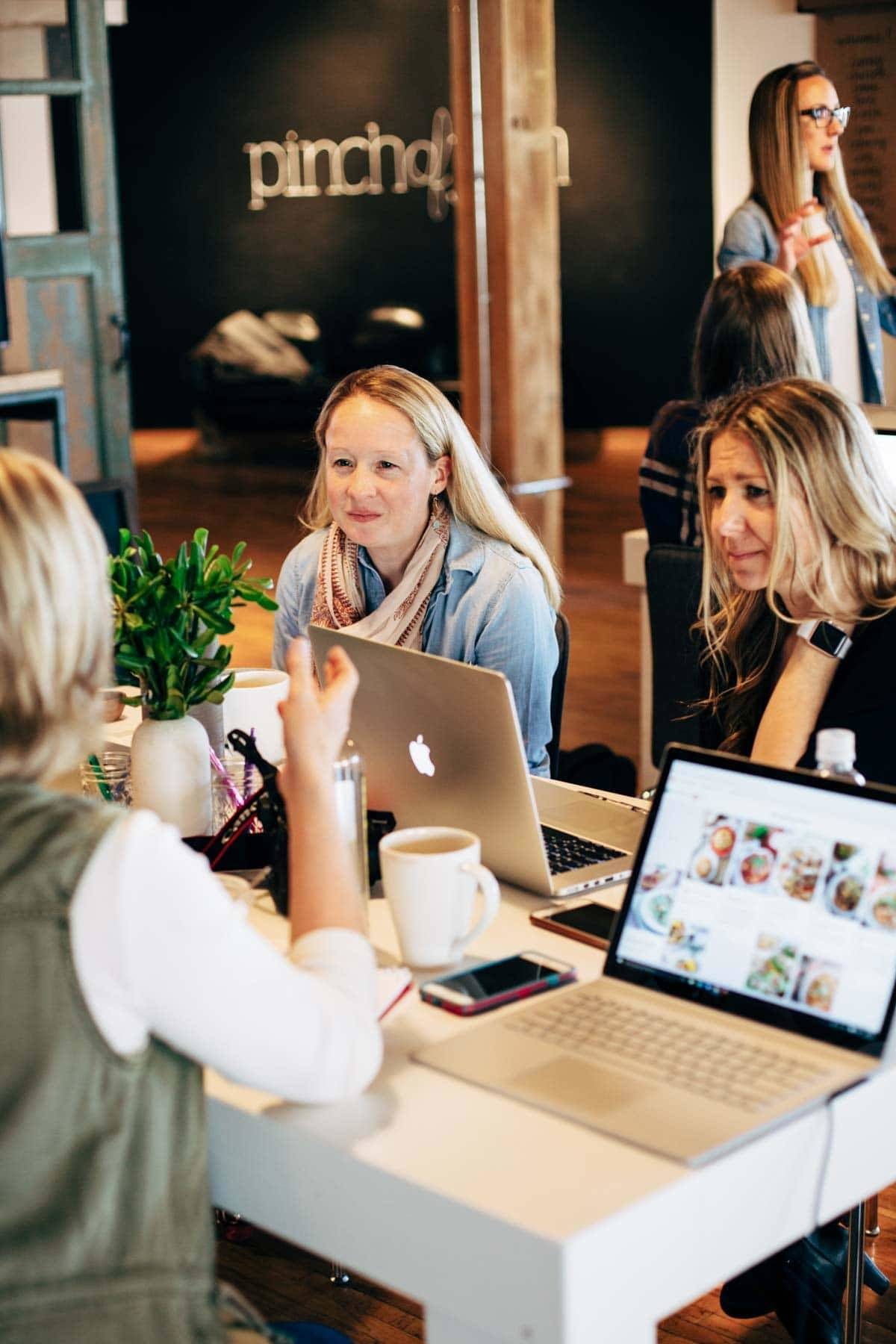 Women sitting at a table talking.
