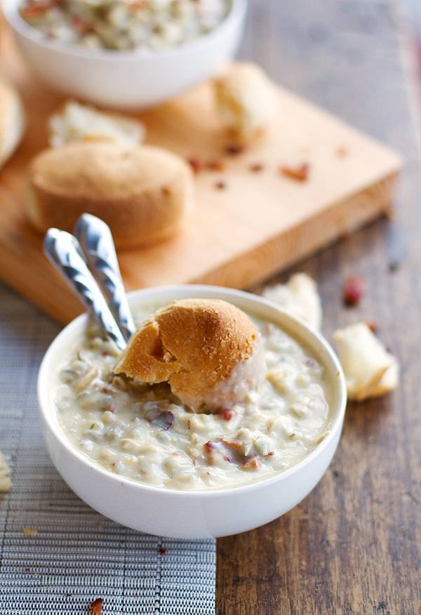 Chicken bacon wild rice soup with a piece of bread.