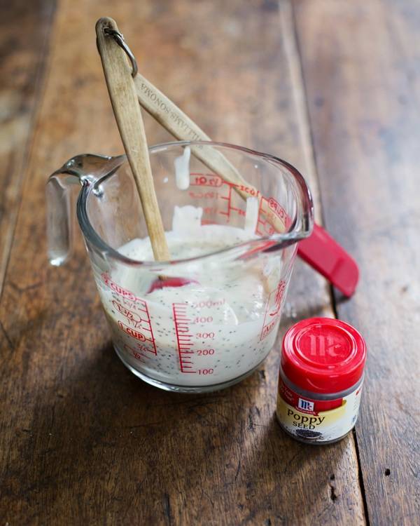 Poppy seeds and liquid in a measuring cup.