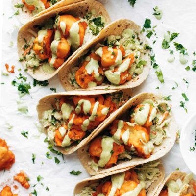 Buffalo cauliflower tacos drizzled with creamy avocado sauce.