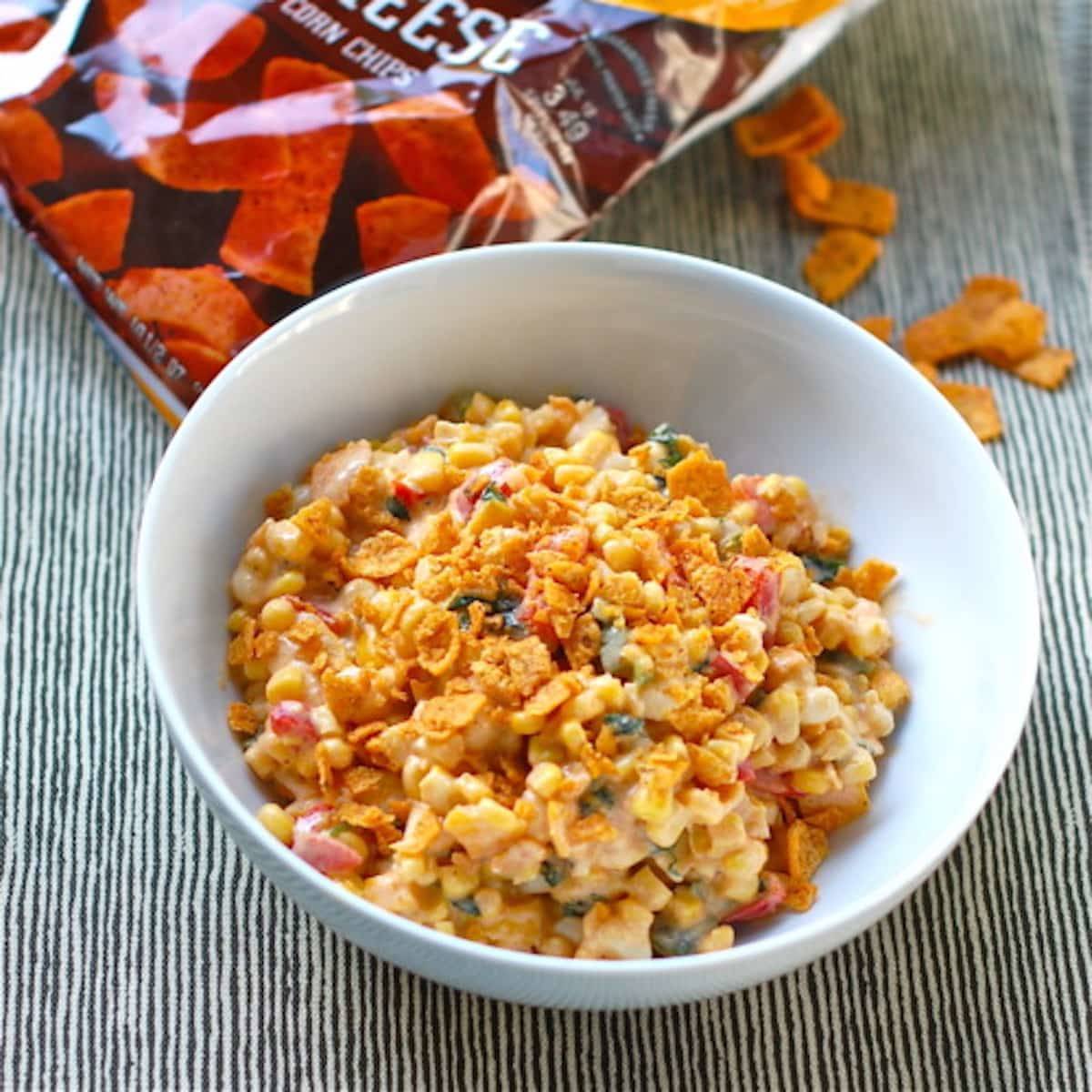 Spicy corn salad with fritos in a bowl.