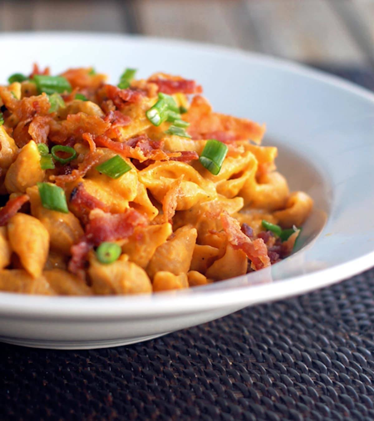 Bacon and pumpkin pasta with a creamy pumpkin sauce, whole wheat pasta shells, and crumbled bacon.